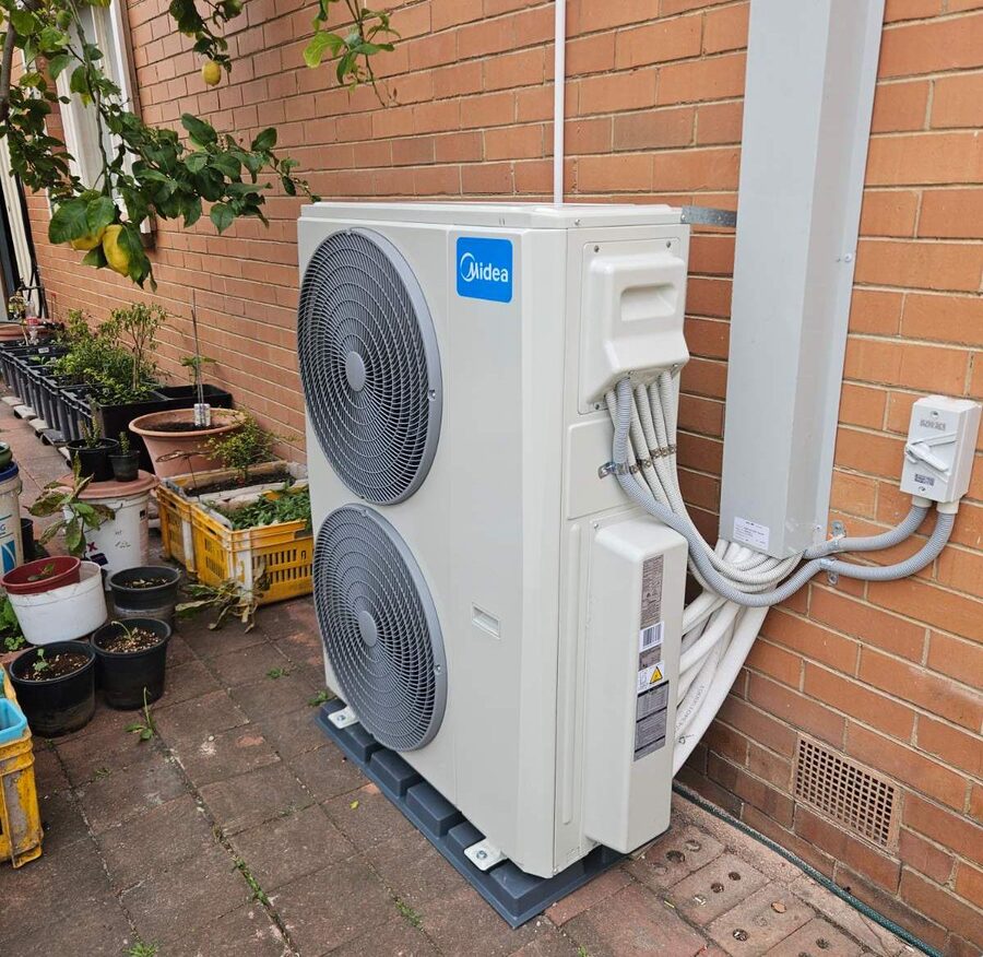 Midea VRF outdoor unit beside garden